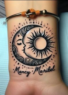 a woman's wrist with a sun and moon tattoo on the side of her arm