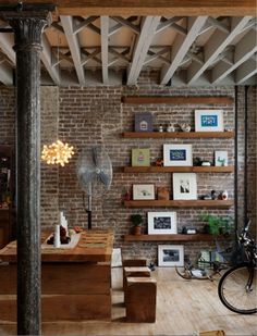 a living room filled with furniture and lots of shelves