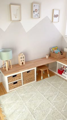 a child's playroom with toys and bookshelves on the floor in front of a white wall