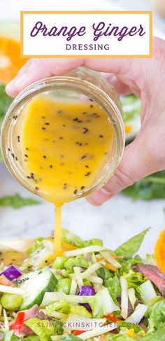 orange ginger dressing being poured onto a salad