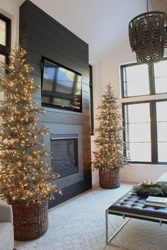 the living room is decorated for christmas with white lights and artificial trees in large baskets