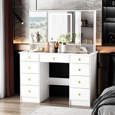 there is a white vanity with two mirrors and drawers in front of the mirror on the wall