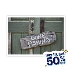 a wooden sign that says gone fishing on it's side next to a door