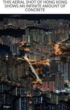 an aerial view of a city at night with lots of tall buildings in the foreground