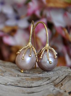 Large Pink Pearl Earrings are a striking blend of natural beauty and contemporary elegance. These Large pink pearl earrings, featuring rare, large pink pearls, are an epitome of sophistication, designed to add a touch of glamour to your ensemble. Pearl Quality: Each earring showcases a very large, near round gold pink freshwater pearl, renowned for its rarity and luminous sheen, making these Large pink pearl earrings truly unique. Metal: The pearls are gracefully suspended from high-quality silver that is gold plated, offering a luxurious look with lasting shine. Design: Inspired by the wonders of nature, these earrings embody a minimalist yet bold style. The large pink pearls make a statement, while the design retains an air of elegant simplicity. Size: The huge pearls ensure these earrin Elegant Pink Teardrop Pearl Earrings, Elegant Pink Pear-shaped Earrings, Pink Teardrop Pearl Earrings For Formal Occasions, Elegant Pink Pearl Earrings For Anniversary, Elegant Pink Gold Pearl Drop Jewelry, Elegant Handmade Pink Gold Earrings, Large Pearl Necklace, Large Bead Necklace, Pink Pearl Earrings