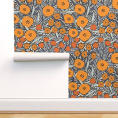 an orange and blue wallpaper with flowers on it