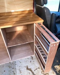 the inside of a van with shelves and drawers