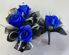 two blue roses with black ribbons on them