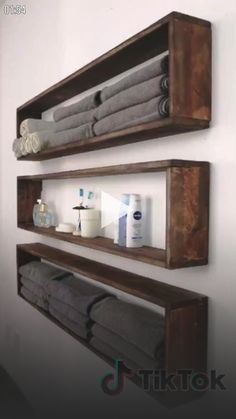 two wooden shelves with towels and soaps on them