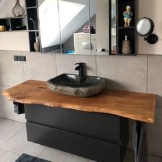 a bathroom with a sink and mirror on the wall