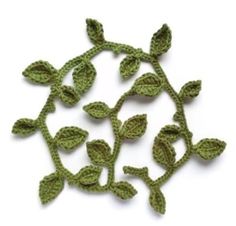 crocheted leaves are shown on a white surface