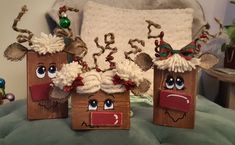 three wooden bags decorated with reindeer heads and noses