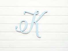 the letter k is painted light blue