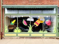 a storefront with an umbrella, watermelon and banana on it