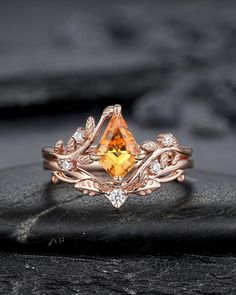 an engagement ring with a yellow topazte surrounded by white diamonds on a rock