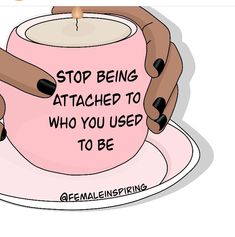 two hands holding a pink coffee cup that says stop being attached to who you used to be