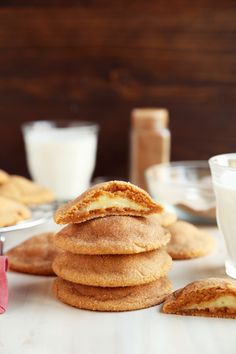 a stack of cookies sitting on top of a table next to a glass of milk