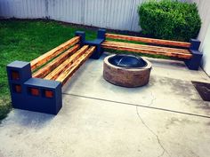 a wooden bench sitting next to a fire pit