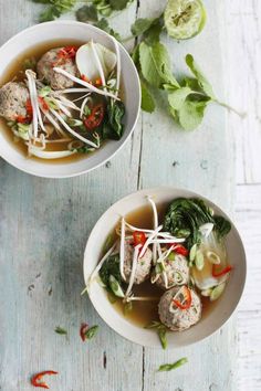 two bowls of soup with meatballs and vegetables