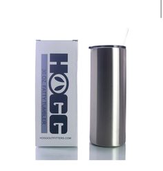 a stainless steel tumbler next to a box of hot stuff on a white background