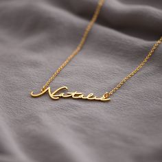 Mon Petit Name Necklace - Gold Plated | Oak & Luna Gold Engraved Signature Necklaces, Elegant Everyday Name Necklace With Cable Chain, Elegant Everyday Engraved Name Necklace, Elegant Everyday Nameplate Necklace, Everyday Elegant Nameplate Necklace, Everyday Signature Gold Jewelry, Gold Name Necklace With Cable Chain As Gift, Gold Name Necklace With Cable Chain For Gift, Elegant Gold Name Necklace With Cable Chain