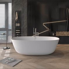 a large white bath tub sitting on top of a wooden floor