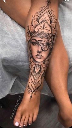 a woman's leg with a tattoo on it and her face in the middle