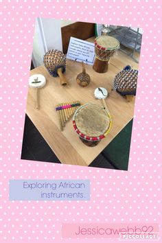 a table with various items on it and a sign that says exploring african instruments lesson