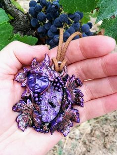 Description: The spirit of the grapes has awakened to communicate with humanity to show them the power of the water of life that comes out of its fruits, the power of healing and balance for life. Listen to his message by doing a meditation with him and he will imbue you with wisdom and vitality. This pendant measures 60 mm wide by 65 mm long, 25 grams of weight on a fully adjustable vegan suede necklace with slide bead. This pendant is made with charoite cabochon and polymer clay. Delivery time Spiritual Purple Pendant Jewelry, Collectible Spiritual Purple Necklace, Mystical Purple Pendant Necklace, Spiritual Purple Cabochon Jewelry, Purple Amethyst Amulet Jewelry, Purple Amethyst Amulet Necklace, Gold Print, Hippie Boho, Grapes