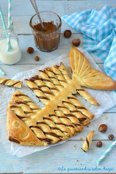 a pastry shaped like a fish sitting on top of a table next to some nuts