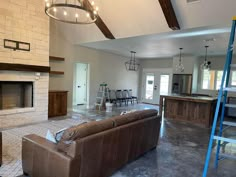 a living room filled with furniture and a fire place in the middle of a kitchen