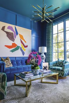 a living room with blue walls and furniture