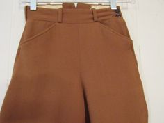 "Vintage 1950s jodhpurs, horse riding pants or motorcycle pants. Made of rust brown wool twill. Has a zip side, two waist pockets and button cuffs. Made by Brittany Riding Apparel. Size small or extra small. Actual measurements are: 21.75\" at the waist 37\" hips 18.5\" inseam 29.5\" overall length In good condition with some spots." Classic High Waist Brown Pants, Vintage Trousers For Winter, Vintage Winter Trousers, Vintage Full-length Winter Pants, High Waist Brown Bottoms With Belt Loops, Vintage Winter Workwear Bottoms, Vintage High Waist Winter Pants, Vintage Brown Pants For Fall, High Waist Brown Pants With Belt Loops