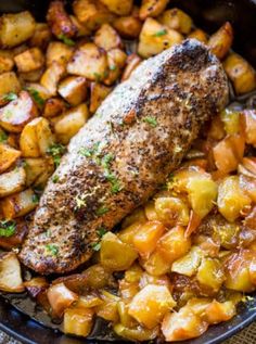 fish, potatoes and carrots in a skillet