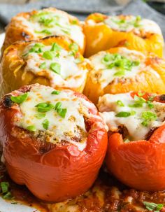 stuffed bell peppers with cheese and herbs on a white plate, ready to be eaten