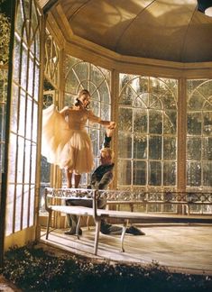 a man and a woman standing in front of a window with a ballerina on it