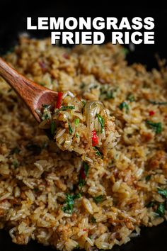 a wooden spoon full of lemongrass fried rice on a black plate with the words lemongrass fried rice above it