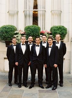 a group of men in tuxedos standing next to each other