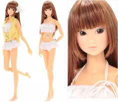 a doll with brown hair wearing a yellow shirt and white skirt is posed next to another doll