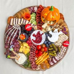 a plate filled with lots of different types of food on top of a white table cloth