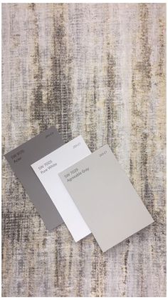 two different shades of gray and white on a carpet with the same color swatches