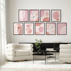 a living room filled with white furniture and pictures on the wall