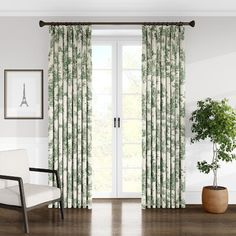 a living room filled with furniture and a large window covered in green curtains next to a potted plant