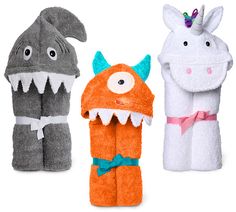 three stuffed animals in different colors and sizes, one with an animal's mouth