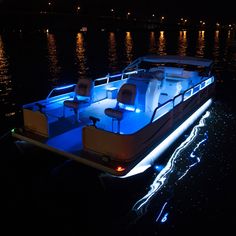 a boat is lit up at night on the water