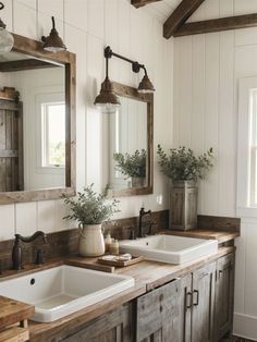 a bathroom with two sinks and mirrors on the wall