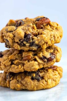 three oatmeal cookies stacked on top of each other with raisins