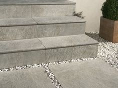 a concrete bench sitting next to a planter