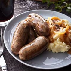 two sausages and mashed potatoes on a plate