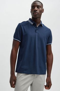 Model Height: 6'2 - Wearing Large Big & Tall: Height 6'3- Wearing XXXL Available In Black, White, Grey, Pink, Red, Navy, Neon Pink, Neon Yellow, Green, Yellow, Light Blue, and Coral Fold Down Collar 3 Button Closure Short Sleeve 100% Cotton Imported | Mens Wilson Short Sleeve Polo in Navy Blue size Small by Fashion Nova Navy Fitted Collared Tops, Fitted Navy Collared Tops, Fitted Collared Navy Tops, Navy Fitted Tops With Collared Neckline, Navy Fitted Top With Collared Neckline, Navy Collared Cotton Tops, Navy Polo Collar Top For Spring, Navy Relaxed Fit Collared Top, Navy Collared Top With Relaxed Fit